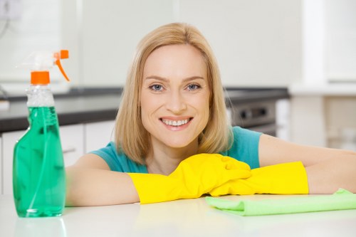 Office cleaning team sanitizing desks and common areas